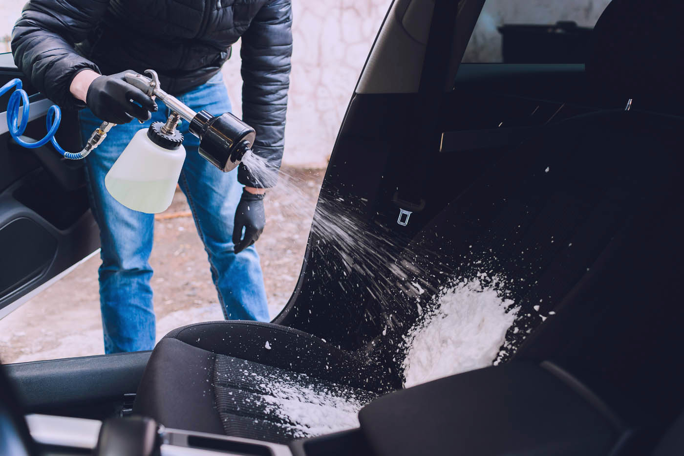 Dapper Pros professionals using safe equipment and cleaning supplies to do car deep cleaning.