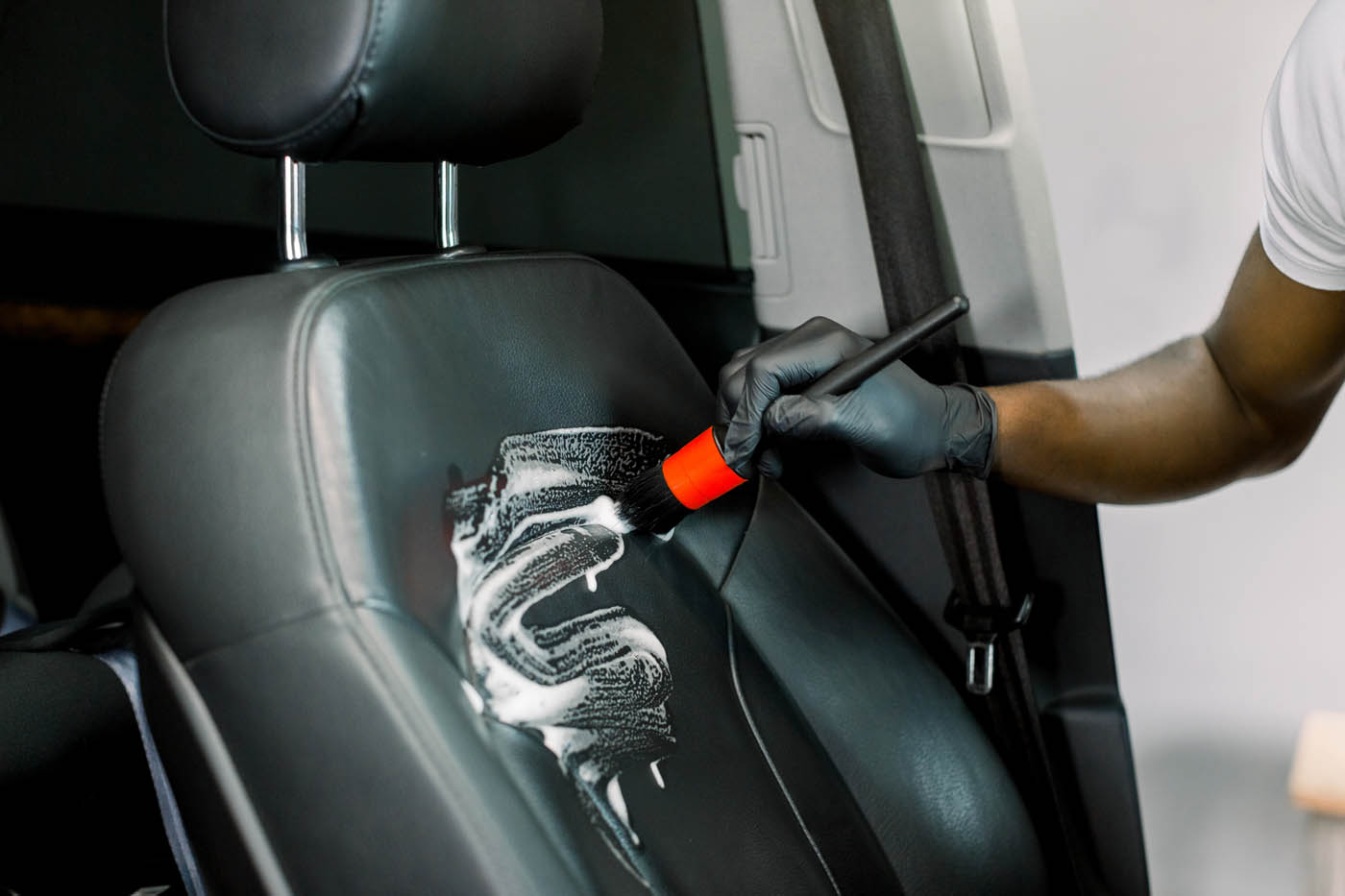 Dapper Pros providing a leather revive at their car detailing shop.