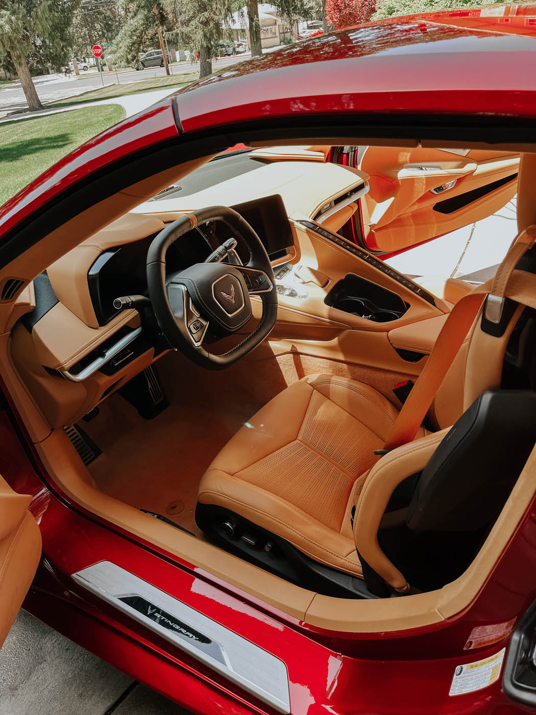 Inside a red corvette, looking fresh and cleaning after Dapper Pros's mobile auto detailing.