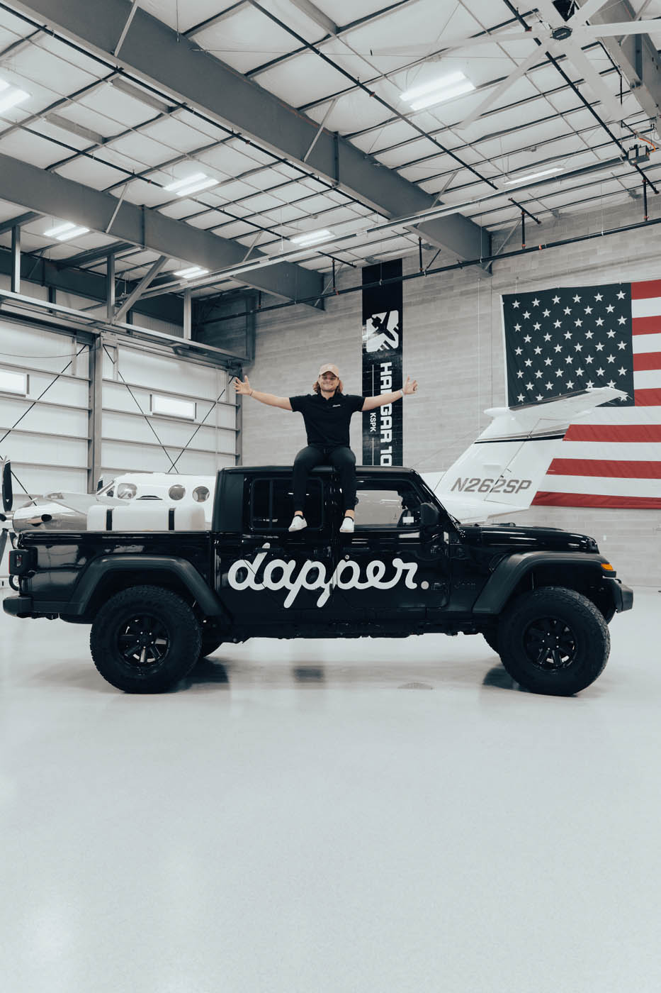 Dapper Pros owner sitting on the Dapper Pros jeep truck, book online today for RV washing.