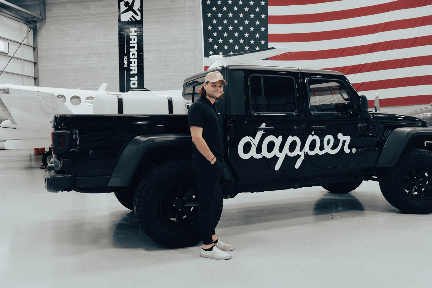 Dapper Pros owner standing in front of the Dapper jeep truck.