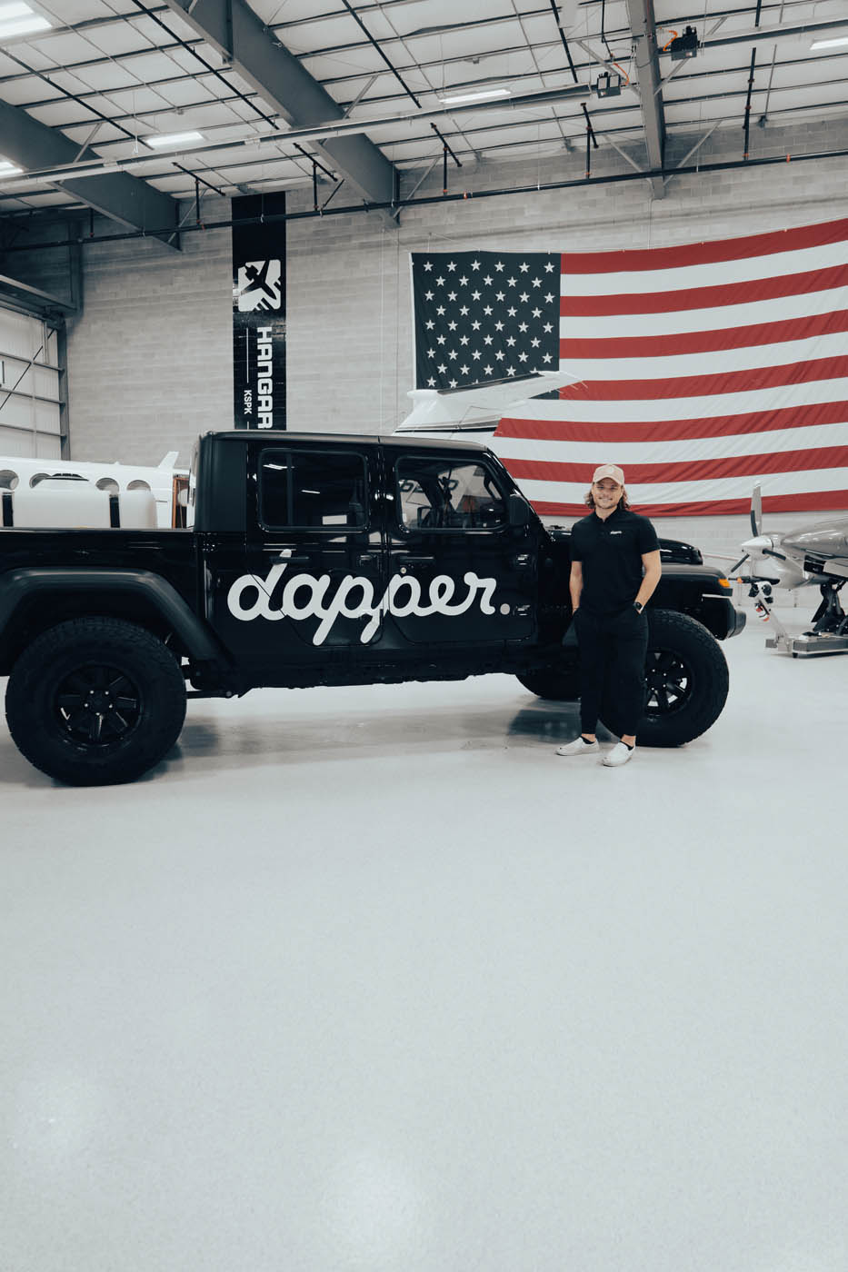 Dapper Pros owner standing in front of the Dapper Pros jeep truck.