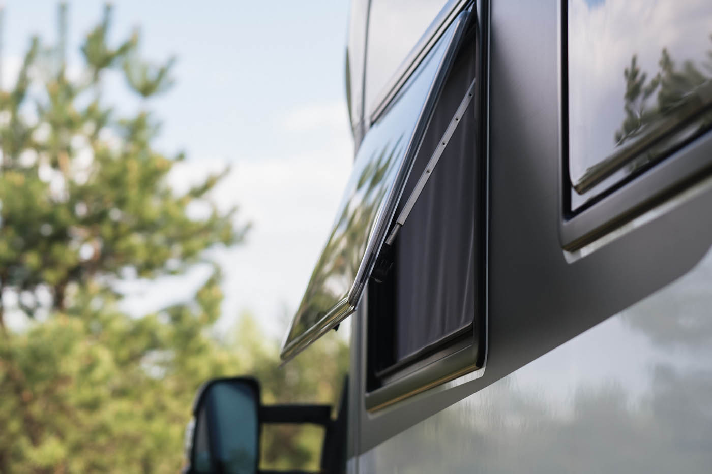 An open RV window airing out a freshly cleaned RV provided by Dapper Pros.